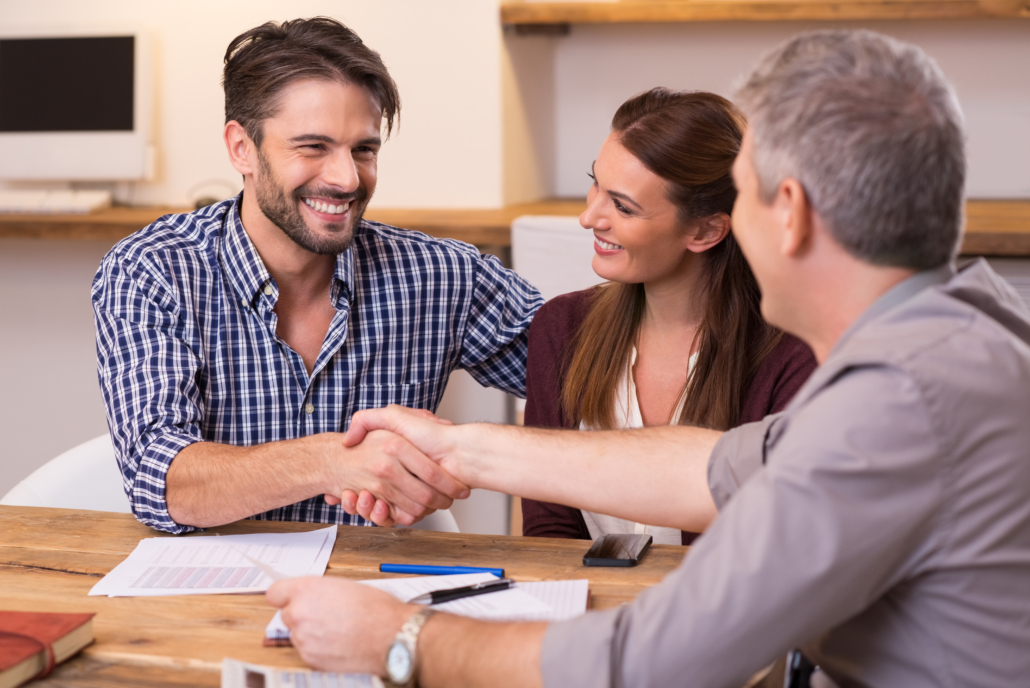 Young couple shaking hands with debt relief consultant